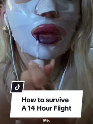 The cover image features a close-up of a person wearing a white face mask. Their lips are prominently on display, appearing glossy and stained with lip color. White earbuds are visible, suggesting they are listening to something. A text overlay reads, 'How to survive A 14 Hour Flight,' with the word 'Me:' below it.