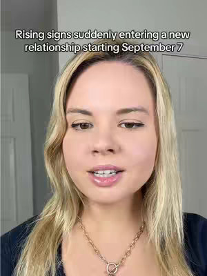 A woman with blonde hair, wearing a gold necklace, faces the camera and speaks. Text overlayed on the top of the frame communicates info about predictions.