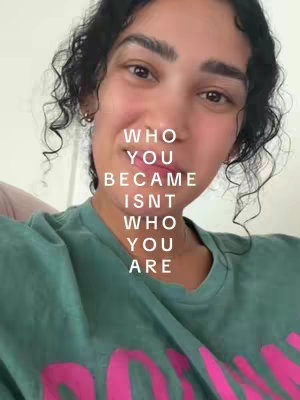 A close-up shot of a woman with curly dark hair, a green t-shirt, and text overlaid on the image