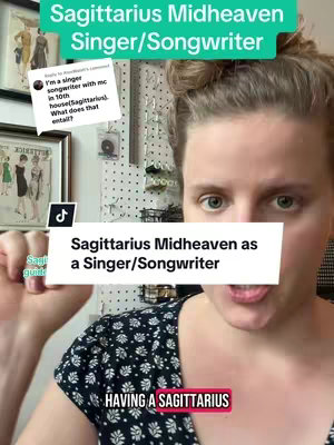 A woman with light skin and pulled-back brown hair stares directly at the camera in a home setting, with a plain wall in the background. She has a small tattoo on her thumb of a sagittarius sign. The image is overlaid with various text elements that detail the video's astrology and songwriting themes.