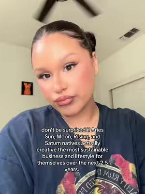 A woman with dark hair is centered in the frame, looking toward the camera. She is wearing a dark-colored shirt. Text overlay is present at the bottom, offering a description of her zodiac sign.