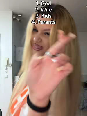 A woman with long blonde hair is in a room, holding her hand up with fingers extended, near her face. Text overlays the image, listing numbered items.
