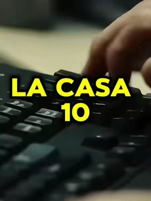The cover image shows a close-up of a black computer keyboard with the text 'LA CASA 10' in large yellow letters overlaid on top. A hand is visible, in the process of typing or pressing a key on the keyboard. The overall color scheme is dark, with shadows and subdued lighting.