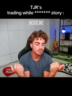 A man with curly brown hair is sitting in what appears to be a home office or streaming setup. He looks at the camera and has his arms outstretched, with thumbs up indicating the story is starting. Above him is text that says 'TJR's trading while ******** story :'. Behind him, KICK logo and a shelf with items are visible.. The background is a plain wall and a rug. The overall composition suggests a casual, conversational video with a focus on financial content.