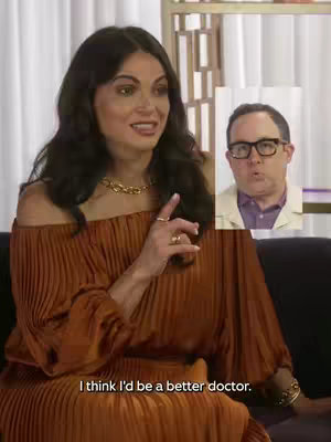 A woman in a rust-colored, off-the-shoulder dress gestures and smiles while speaking. In the upper right corner, a small inset image of a man wearing glasses appears to be reacting. Text at the bottom reads, 'I think I'd be a better doctor.'
