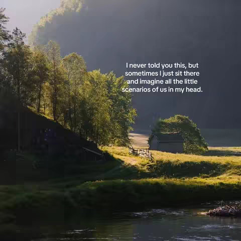 A picturesque landscape featuring a river in the foreground, with lush green foliage and trees lining the banks. In the midground, a small wooden structure is nestled amongst the trees, bathed in sunlight. The background consists of rolling hills or mountains shrouded in a soft mist, creating a serene, natural setting.
