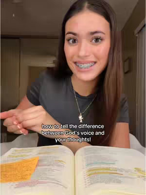 The cover image features a young woman smiling directly at the camera with a bible open in her lap. The text "how to tell the difference between God's voice and your thoughts!" is overlaid, complemented by a blurred background that suggests a domestic setting. She is wearing a cross necklace and braces.