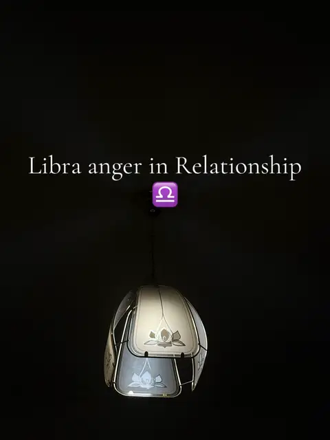 A vertical image with a dark background. In the center of the frame is a light fixture with a decorative glass lampshade. The shade design includes light and dark shapes with a floral pattern. On the central axis, over the lampshade, is the Libra zodiac symbol overlay. The top of the image contains the text 'Libra anger in Relationship'. The overall composition presents a moody, mysterious feel.