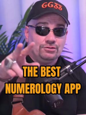 A man with sunglasses and a black hat that reads GG33 is pointing at the camera with a sign overlay that states "THE BEST NUMEROLOGY APP."