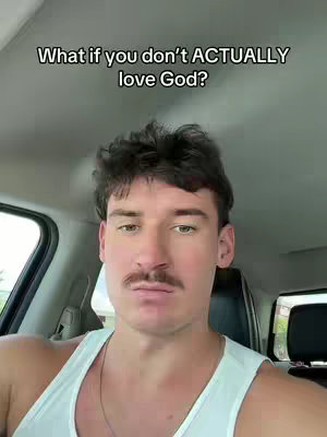 A man with dark hair and a mustache is positioned inside a car, wearing a white tank top. The focus is on his face, with a text overlay at the top.