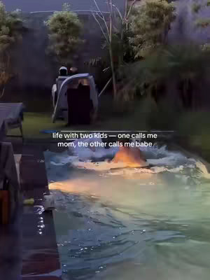An outdoor scene at dusk with a lit pool. The water reflects the sky and light, partially obscuring a person swimming. A white boat-like structure is visible in the center. Trees and foliage frame the scene, with text overlaid at the bottom.