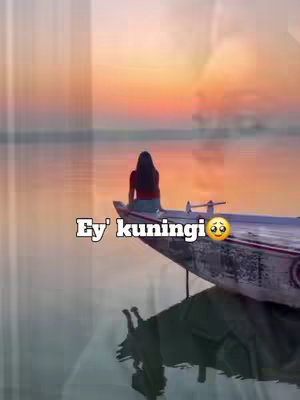 The cover image depicts a serene scene with a woman sitting on the edge of a boat at sunset. The sky transitions from shades of orange and gold to a deep blue as the sun dips below the horizon. A lone figure with long hair sits facing away from the camera, gazing towards the setting sun. The boat's reflection is visible in the calm water. Text overlayed features a caption, "Ey' kuningi",