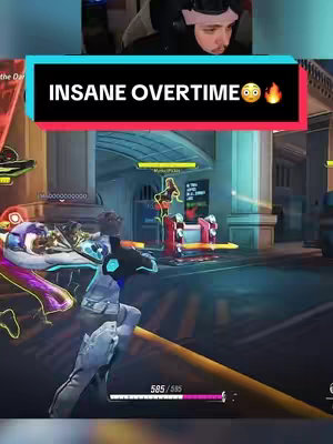 The cover image shows a split-screen. In the top portion, the streamer is visible, with a headset. The bottom section shows a vibrant, colorful video game scene with multiple characters in action. Text overlays are present, with the streamer's overlay in a banner across the top middle.