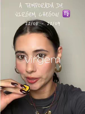 A selfie-style photo shows a woman with dark hair and makeup, holding a small yellow smiley face charm. Text overlays include astrology-related phrases and dates.