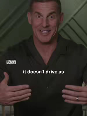 The cover image is a selfie-style shot featuring a man from the chest up. He has short, graying hair and is wearing a dark green button-up shirt. His facial expression is friendly and inviting, with open eyes and a slight smile. The background is out of focus, but appears to be indoors. Text overlay reads 'it doesn't drive us' in white.