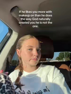 The cover image shows a young woman sitting inside a car, looking towards the camera with a slightly questioning expression. The background includes a glimpse of the car's interior and some of the outside environment. The text on-screen overlaying the image states, 'If he likes you more with makeup on than he does the way God naturally created you he is not the one.'
