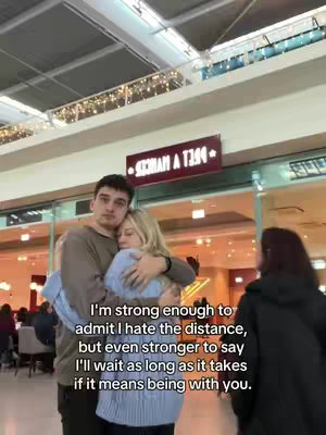 The cover image shows a couple embracing in a shopping mall setting. The man is on the left, with dark hair and a neutral expression, embracing the woman. She has blonde hair and is snuggled against him. They are framed within a brighter lit area amid a darker, out-of-focus background with a sign in the distance.