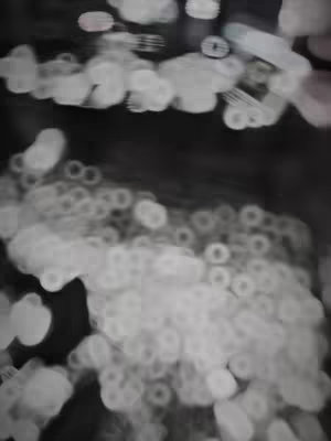 An abstract image dominated by blurred white shapes against a dark background, creating a sense of depth and movement. The effect suggests a dreamy or ethereal atmosphere.