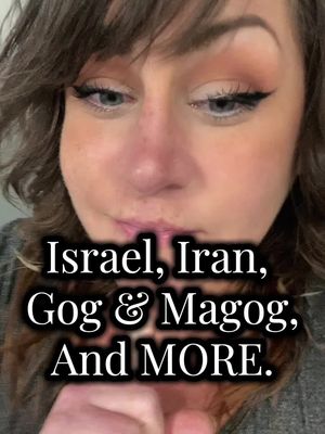 A close-up shot of a woman's face, with a visible text overlay. The woman has light skin, dark eyebrows, and is looking slightly down towards the text. The background is a simple, blurred indoor setting. The makeup includes eyeliner and possibly blush. The hair is dark and wavy.