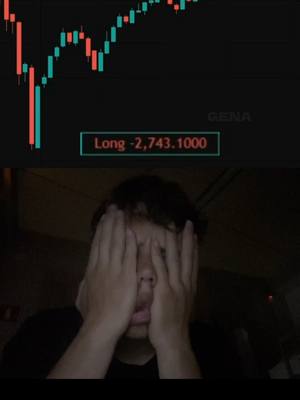 The image shows a person with their hands covering their face, likely in a distressed pose, set against a dark background. Above them is a chart displaying financial data, specifically a candlestick chart with both red and green segments, implying market fluctuations. There is also a text overlay indicating "Long -2,743.1000". The overall composition suggests a reaction to financial loss or difficulty in trading.
