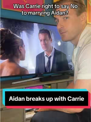 The cover image shows a man on the right side of the frame, looking slightly off-camera. On the left, a television screen displays a scene from a show with a woman and another man in a suit. Text overlays at the top reads, 'Was Carrie right to say No to marrying Aidan?'. A red rectangle at the bottom reads, 'Aidan breaks up with Carrie'.