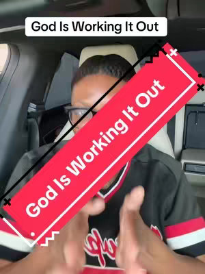 A person with glasses and a black and red jersey is inside a car. The video overlay says "God Is Working It Out" in a red rectangle, with a white outline.