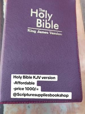 The image shows a closed, purple Holy Bible. The text 'The Holy Bible, King James Version' is embossed in white metallic font on the cover. A white rectangular text box at the bottom contains the text 'Holy Bible KJV version, -Affordable, -price 1000/=, @Scripturesuppliesbookshop'.