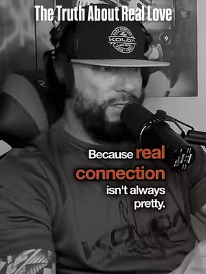 A black and white image of a man speaking into a microphone. He's wearing a hat with a logo. Text overlays state: 'The Truth About Real Love' and 'Because real connection isn't always pretty'. The background is blurred and features a wall.