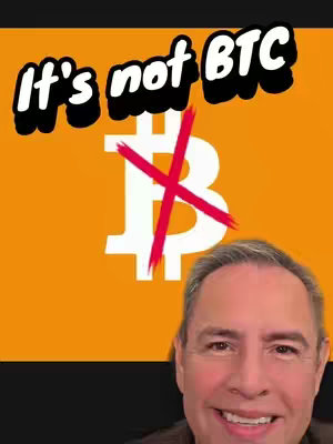 The cover image features a man's smiling face in the bottom third, against an orange background. Overlayed is the text 'It's not BTC' in a bold, white font with a black outline. A red 'X' is drawn across a stylized white 'B'. The overall layout suggests a statement about Bitcoin.