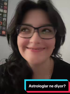 A woman with dark hair and glasses smiles up towards the top right of the frame. She's wearing a black top, and a title overlay at the bottom says, "Astrologlar ne diyor?"