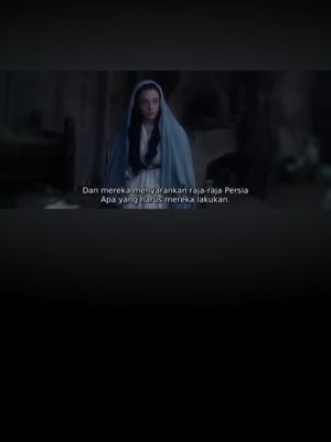 The cover image is a screenshot featuring a person, assumed to be a central character, inside a dimly lit setting. The individual is draped in a blue cloak with a matching hood, emphasizing their central position. The background is blurred, suggesting the shallow depth of field that focuses on the protagonist. Text overlay at the bottom provides context or commentary.