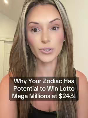 A woman with long blonde hair is centered in the frame, facing the camera and speaking. A text overlay at the bottom reads, "Why Your Zodiac Has Potential to Win Lotto Mega Millions at $243!". The background appears to be a room, likely inside a house due to the interior wall and sliding door. The lighting is bright and even, indicating it might be natural light or well-placed studio lights.
