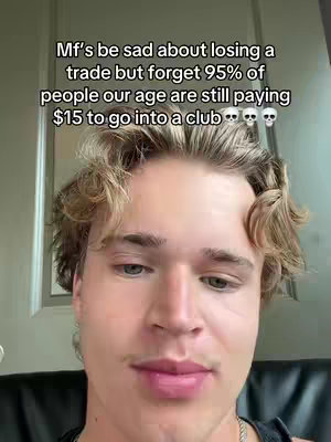 A close-up shot of a young man with light brown hair, slightly tousled. He is the focus of the image, framed from the chest up. The background is blurred, with a door visible on the left, and the lighting appears to be soft. The man has a neutral expression, looking directly at the camera. Overlayed text is present at the top of the image.