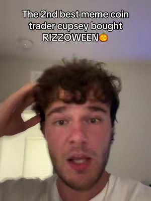 A close-up selfie of a young man with brown curly hair, wearing a white t-shirt, with text overlaid at the top. The man has a slightly concerned expression and is touching his hair. The background is dimly lit, suggesting an indoor setting.