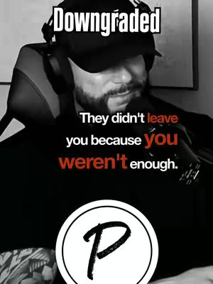 A grayscale image features a man in a black cap and hoodie speaking into a microphone. Text overlays are placed at the top, reading 'Downgraded', and toward the bottom with the phrase 'They didn't leave you because you weren't enough.' A circular logo with the letter 'P' is at the bottom.