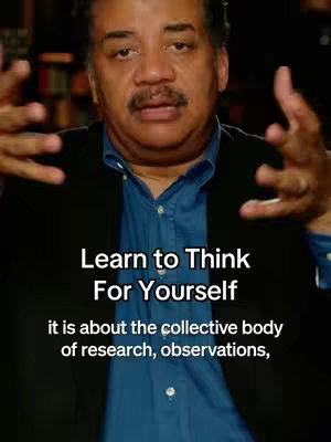 A medium shot features a Black man from the chest up. He has short, neatly-groomed black hair and a mustache. He is wearing a blue dress shirt and a black blazer. The background appears to be a blurred indoor setting with bookshelves visible. Text overlays are at the bottom third of the image.