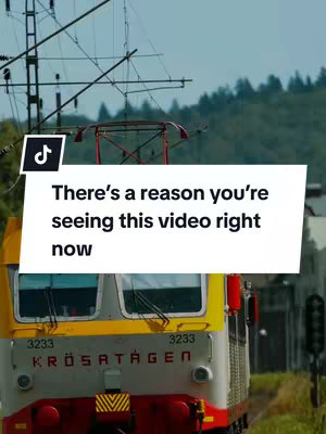 The image shows a train, with an overhead text overlay and the TikTok logo in the upper left corner. The train is yellow, gray, and red, with the words "KRÖSATÅGEN" on the front. The sky is cloudy, and utility lines are visible.