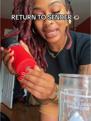 The cover image shows a woman with reddish-brown dreadlocks holding a large red candle in front of her. She’s smiling slightly and looking at the camera. Behind her is a room with a partly visible window and a blurred background. "RETURN TO SENDER" is written at the top.