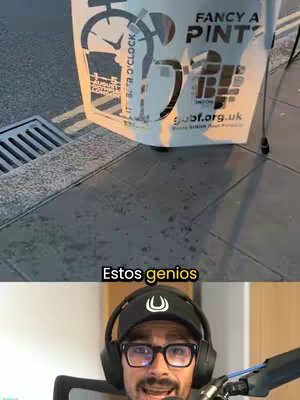 The cover image is a split-screen. The top half features an urban setting, with a metallic grate, and a sign for a beer brand, with text 'FANCY A PINT?' and 'IT'S BEER O'CLOCK' partially visible. The sign's design is predominantly black and white. The bottom half of the image shows a man wearing a black cap and glasses. He is looking directly at the camera with a smile.