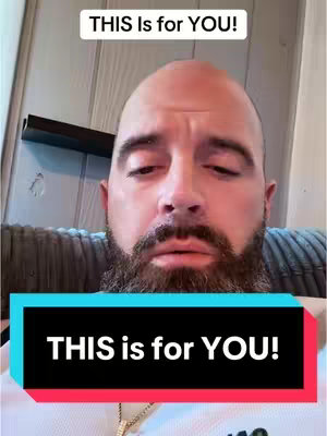 A man with a beard looks down with a slightly sad expression, with overlayed text boxes that read “THIS Is for YOU!”. The background shows part of a sofa.