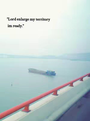 The image shows a vast expanse of water, likely a river or lake, under a slightly overcast sky. A large, industrial-looking ship is sailing in the distance. In the foreground, a red railing of a bridge or similar structure is visible, with a portion of the gray concrete beneath it. The overall color palette is cool, with blues, grays, and hints of red.