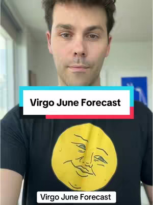 A man stands facing the camera with text overlays. He wears a black t-shirt that has a yellow illustrated smiling moon face on it. The background is a bright indoor space with white walls and a window.