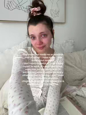 A somber shot shows a young woman in pajamas, sitting on a bed and crying, with a text overlay. The background is a simple room with a painting, suggesting a personal and intimate setting.