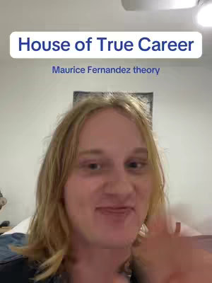 A selfie-style video cover image with a person in the frame. The person is a blonde woman facing the camera with a friendly, slightly smiling expression. The background features a white wall with what appears to be a wall decor in the middle. The main part of the frame is the person's face. The top part of the image features a white rectangle with bold blue text. The overall tone suggests a casual, informative video.