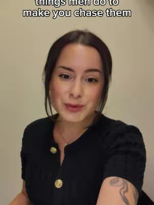 A woman with dark hair and a black top looks toward the camera with a slight smile. Text overlayed on the image reads "things men do to make you chase them". The background is a plain, light-colored wall.