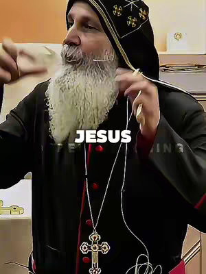 A medium shot features a man with a long, white beard, wearing a black robe and head covering. The word "JESUS" is overlaid in a white, bold font. He is holding something near his chin, and a jeweled cross hangs from his neck.