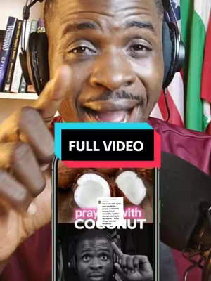 A man with a beard and headphones is pointing a finger at the screen. The screen displays a phone with an image of coconuts and text related to prayer, and another image of what looks like a person also wearing headphones. Behind the man are some shelves with books and a flag.