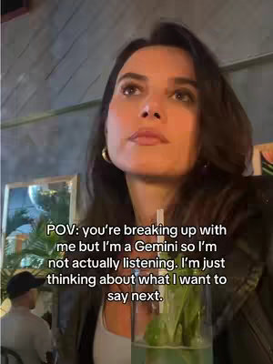A woman with long dark hair looks up to the top right, with a soft background of a restaurant. Text overlay appears top left.