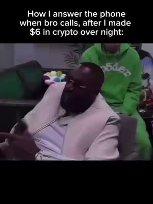 The cover photo features a close-up shot of a Black man wearing glasses and a white suit jacket. He appears to be sitting and gesturing with his left hand while pointing his right index finger. Above the man, there is text on the screen. In the bottom right corner, another person wearing a green hoodie can be partially seen in the background.