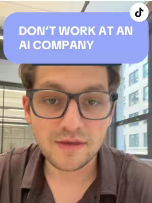 A selfie-style video cover image featuring a man with glasses looking at the camera. A blue rectangle with white text floats above his head. The background consists of windows and an indoor setting.